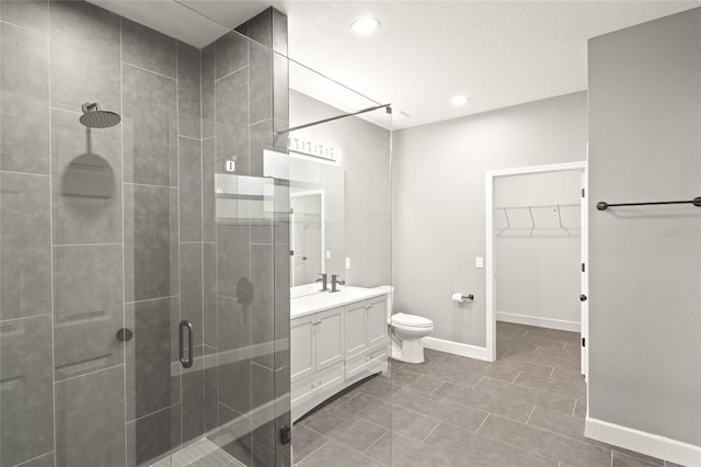 bathroom featuring toilet, vanity, tile patterned floors, and walk in shower