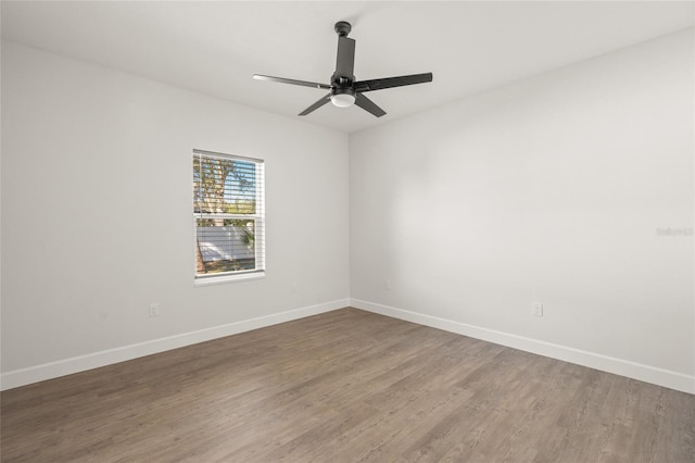 spare room with ceiling fan and hardwood / wood-style flooring