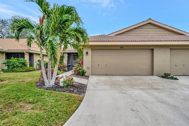 ranch-style home with a garage and a front yard