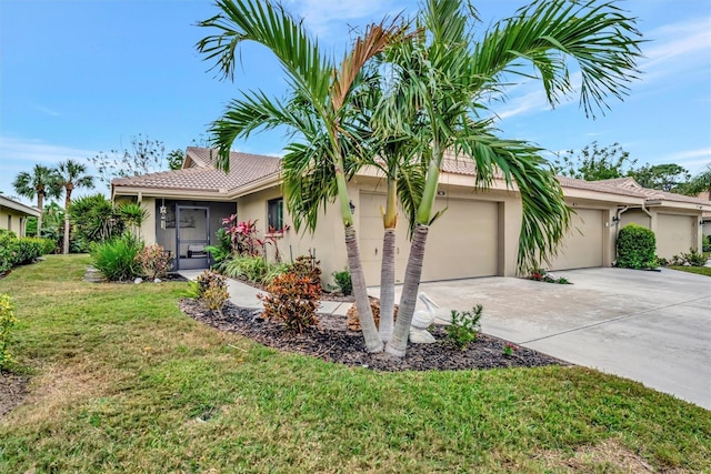 ranch-style house featuring a garage and a front lawn