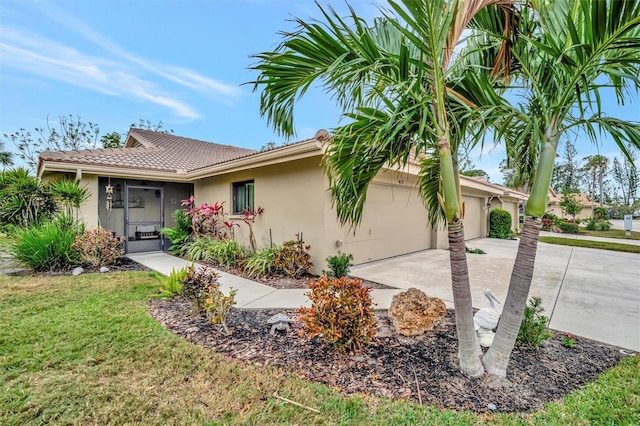 view of front of home with a front yard and a garage