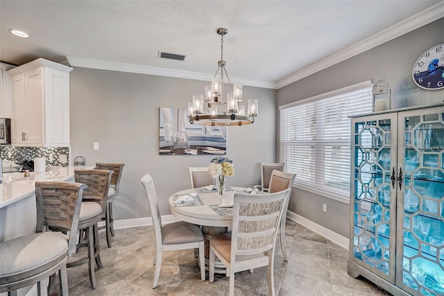 dining space featuring ornamental molding, visible vents, baseboards, and an inviting chandelier