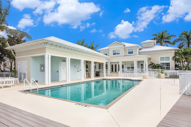 pool featuring a patio area and fence