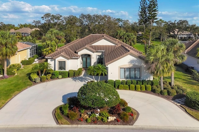 mediterranean / spanish-style house featuring a front lawn