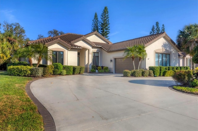 mediterranean / spanish home featuring a garage