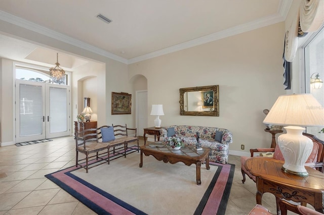 tiled living room featuring crown molding and french doors