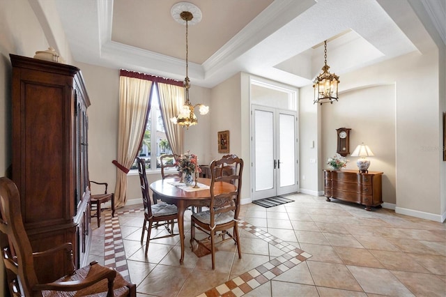 tiled dining room featuring a raised ceiling, ornamental molding, a chandelier, and french doors