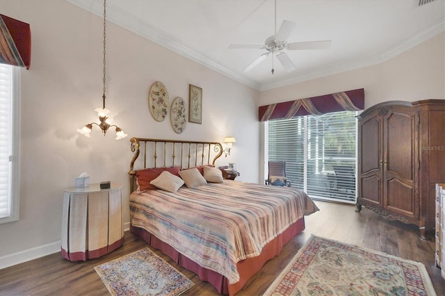 bedroom featuring dark wood-type flooring, ornamental molding, ceiling fan with notable chandelier, and access to outside