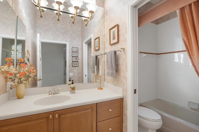 full bathroom featuring bathtub / shower combination, vanity, and toilet