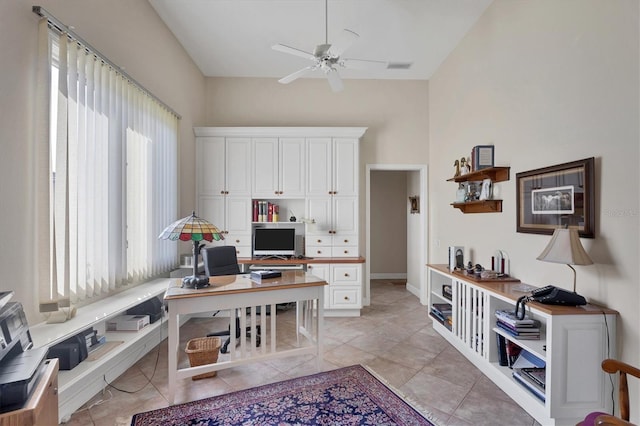 home office with ceiling fan and light tile patterned floors