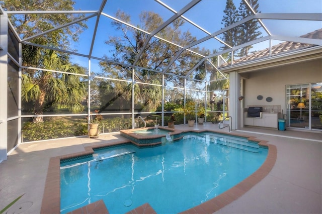 view of pool featuring an in ground hot tub, a lanai, an outdoor kitchen, and a patio area