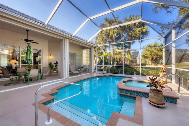 view of swimming pool featuring a patio, a lanai, pool water feature, and ceiling fan