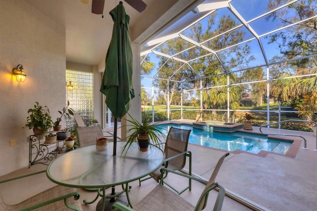 view of pool featuring an in ground hot tub, glass enclosure, and a patio