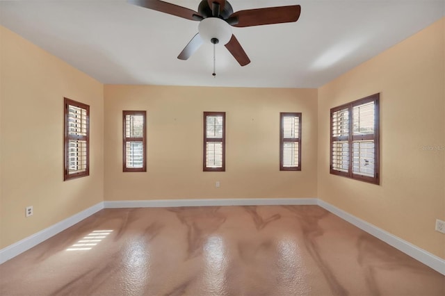 unfurnished room with ceiling fan and a healthy amount of sunlight