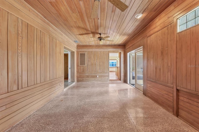 hallway featuring wood ceiling and wooden walls