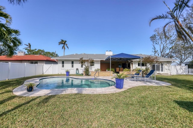 view of swimming pool featuring a yard and a patio