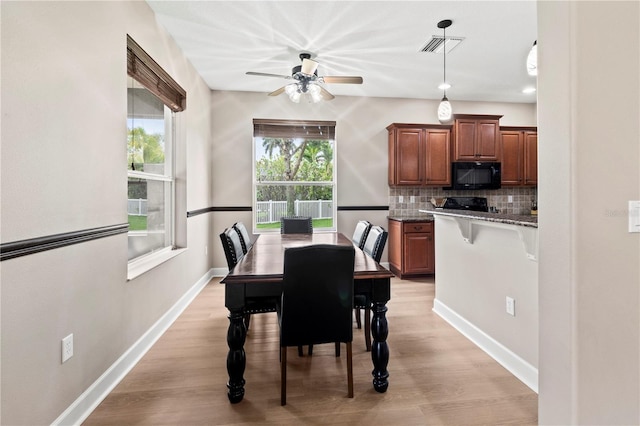 dining area featuring ceiling fan and light wood-type flooring