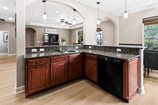 kitchen featuring ceiling fan, sink, dishwasher, and dark stone counters