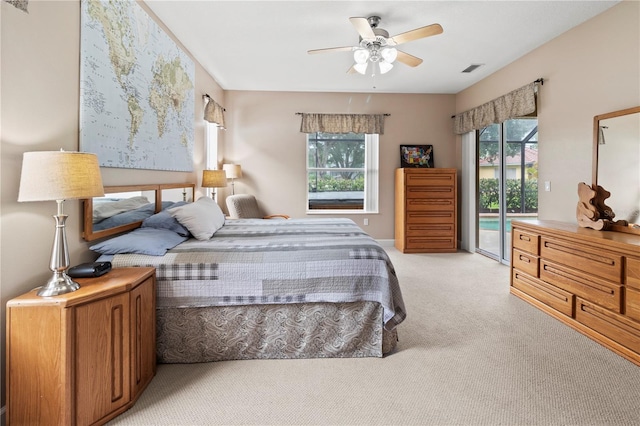 bedroom featuring light carpet, ceiling fan, and access to outside