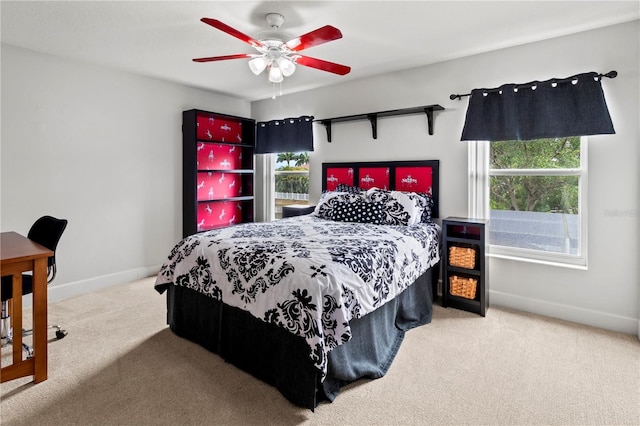 carpeted bedroom with ceiling fan and multiple windows