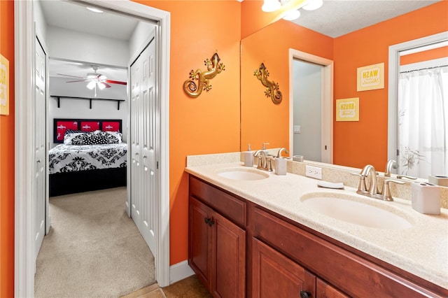 bathroom with ceiling fan and vanity