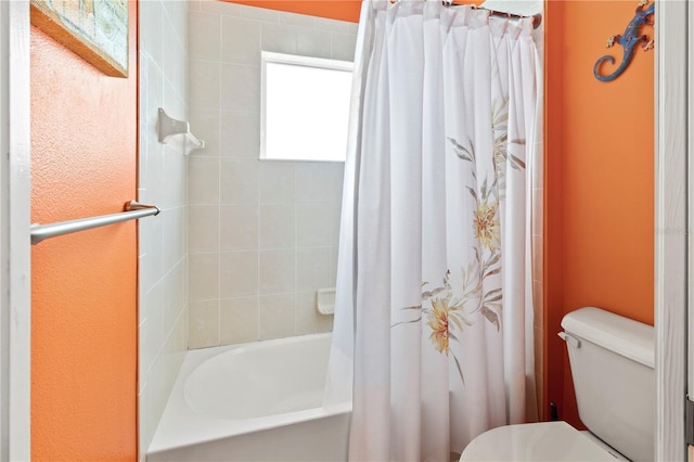 bathroom with toilet and shower / bathtub combination with curtain