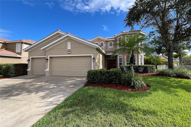 mediterranean / spanish house featuring a front yard and a garage