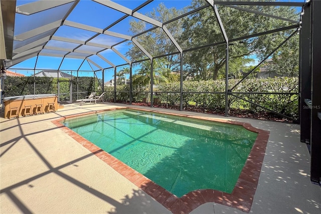 view of pool with a lanai, an outdoor bar, and a patio