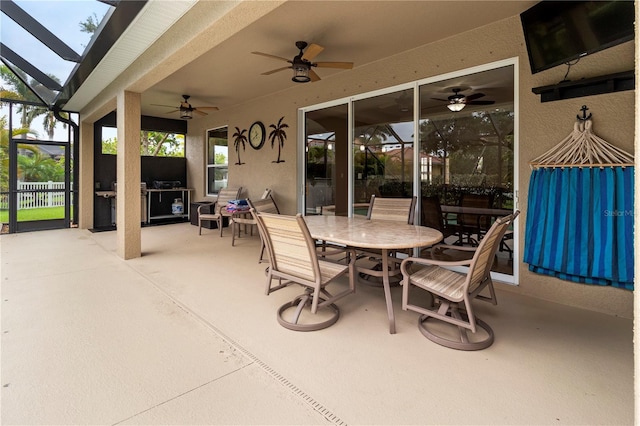 view of patio / terrace featuring ceiling fan and a lanai