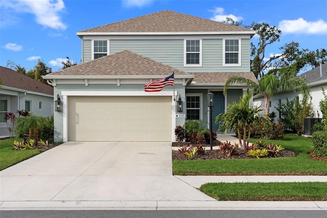 view of property with a garage and cooling unit