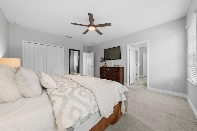 carpeted bedroom with a closet and ceiling fan