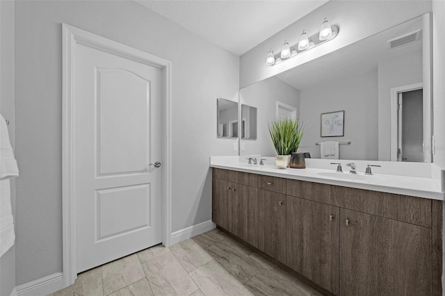 bathroom featuring a textured ceiling and vanity