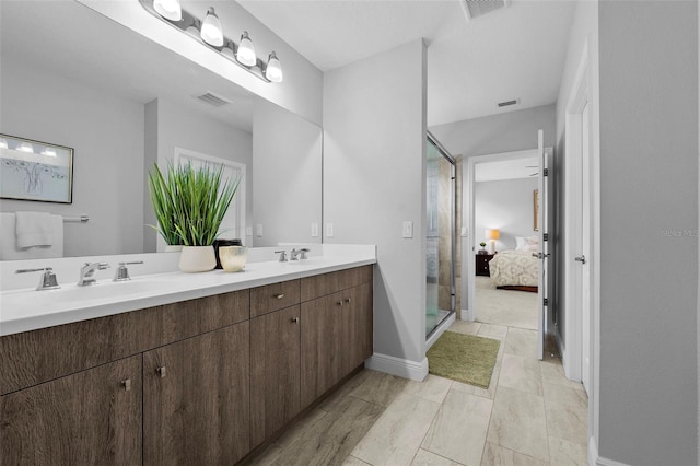 bathroom with vanity and a shower with shower door