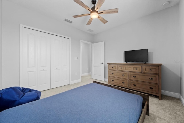 carpeted bedroom featuring a closet and ceiling fan