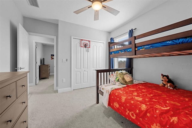 carpeted bedroom with a closet and ceiling fan