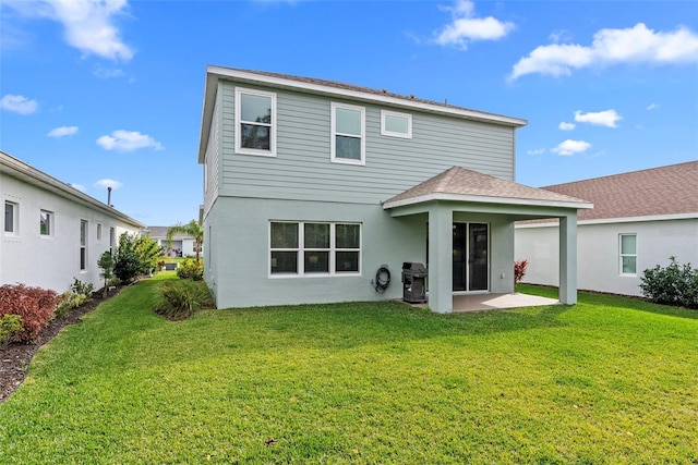 rear view of property featuring a patio and a yard