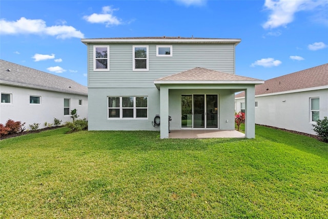 rear view of house with a patio area and a yard