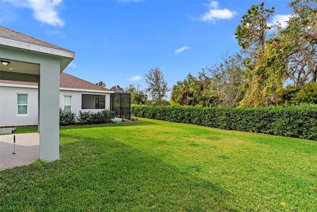 view of yard featuring glass enclosure