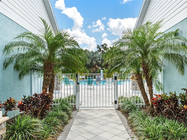 view of gate with a community pool