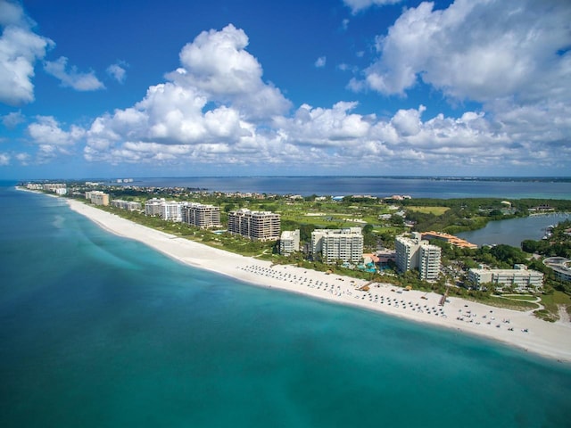 aerial view with a water view and a view of the beach