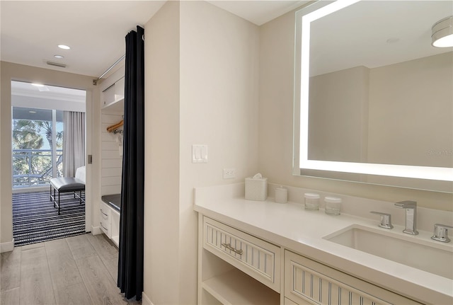 bathroom with vanity and hardwood / wood-style floors