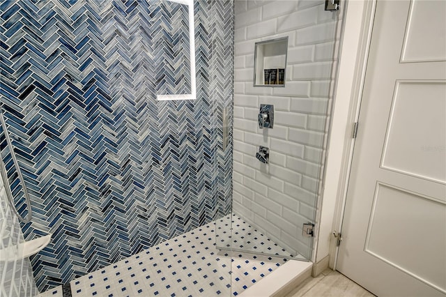 bathroom featuring walk in shower and tile patterned floors