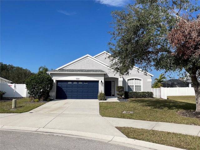 view of front of property featuring a front lawn and a garage