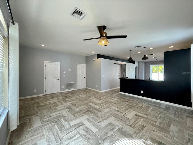 unfurnished living room featuring ceiling fan