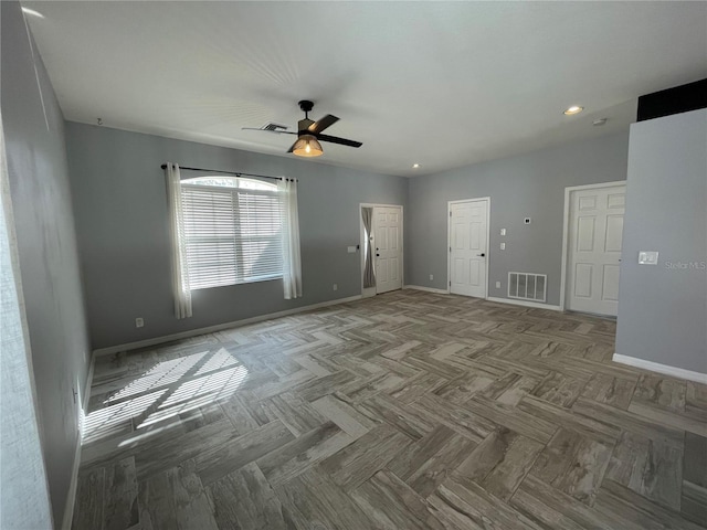 unfurnished room with ceiling fan and parquet flooring