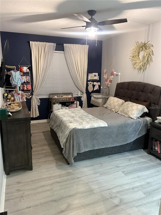 bedroom featuring ceiling fan and light hardwood / wood-style floors