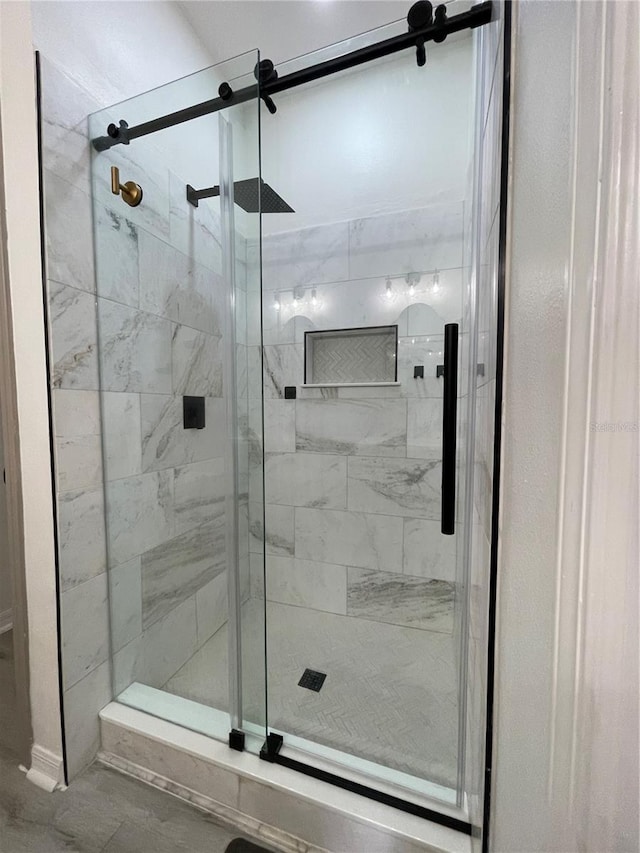 bathroom featuring a shower with door