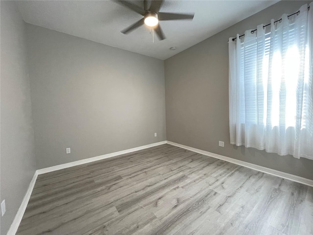 empty room featuring hardwood / wood-style flooring and ceiling fan