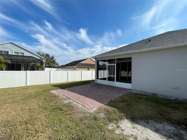 view of yard featuring a sunroom and a patio area