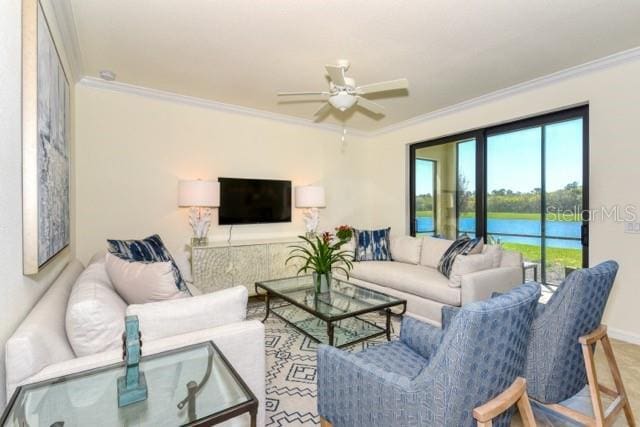 living room with ceiling fan and ornamental molding